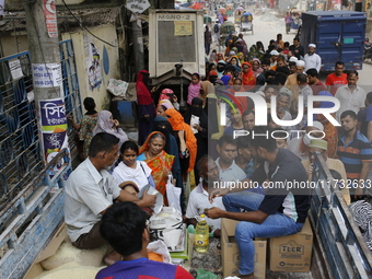 Lower-income people stand in a queue to buy government-subsidized food in Dhaka, Bangladesh, on November 2, 2024. (