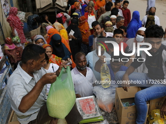 Lower-income people stand in a queue to buy government-subsidized food in Dhaka, Bangladesh, on November 2, 2024. (