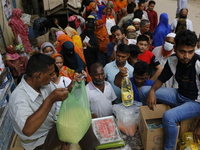 Lower-income people stand in a queue to buy government-subsidized food in Dhaka, Bangladesh, on November 2, 2024. (