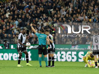 The referee shows a yellow card to Udinese's Keinan Davis during the Italian Serie A Enilive soccer championship football match between Udin...