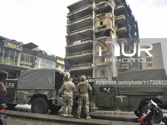 Lebanese security forces take measures in the area after the Israeli attack on an apartment building located at the intersection on the ''Se...