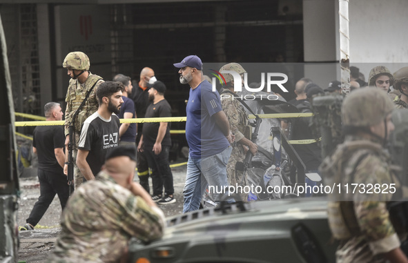 Lebanese security forces take measures in the area after the Israeli attack on an apartment building located at the intersection on the ''Se...