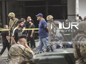 Lebanese security forces take measures in the area after the Israeli attack on an apartment building located at the intersection on the ''Se...