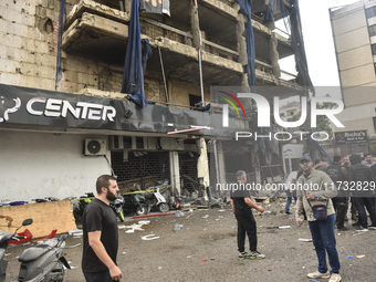 Lebanese security forces take measures in the area after the Israeli attack on an apartment building located at the intersection on the ''Se...