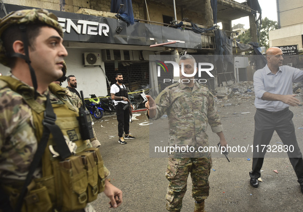 Lebanese security forces take measures in the area after the Israeli attack on an apartment building located at the intersection on the ''Se...