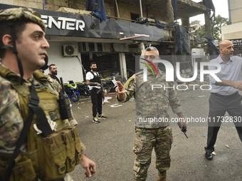 Lebanese security forces take measures in the area after the Israeli attack on an apartment building located at the intersection on the ''Se...