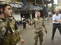 Lebanese security forces take measures in the area after the Israeli attack on an apartment building located at the intersection on the ''Se...