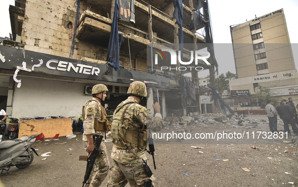 Lebanese security forces take measures in the area after the Israeli attack on an apartment building located at the intersection on the ''Se...