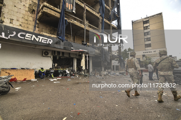 Lebanese security forces take measures in the area after the Israeli attack on an apartment building located at the intersection on the ''Se...