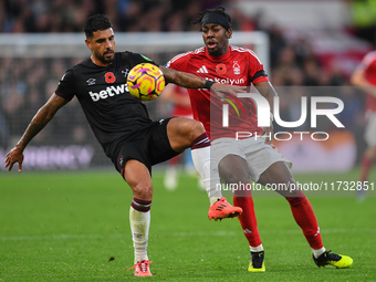 Emerson Palmieri of West Ham United is under pressure from Anthony Elanga of Nottingham Forest during the Premier League match between Notti...