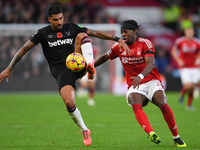 Emerson Palmieri of West Ham United is under pressure from Anthony Elanga of Nottingham Forest during the Premier League match between Notti...