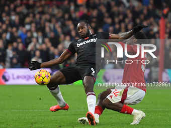 Ola Aina of Nottingham Forest battles with Michail Antonio of West Ham United during the Premier League match between Nottingham Forest and...