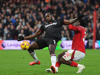 Ola Aina of Nottingham Forest battles with Michail Antonio of West Ham United during the Premier League match between Nottingham Forest and...