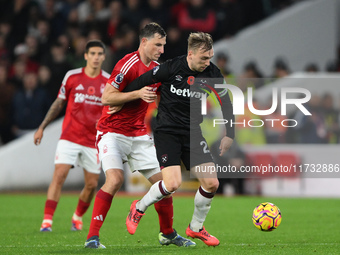 Jarrod Bowen of West Ham United shields the ball from Chris Wood of Nottingham Forest during the Premier League match between Nottingham For...