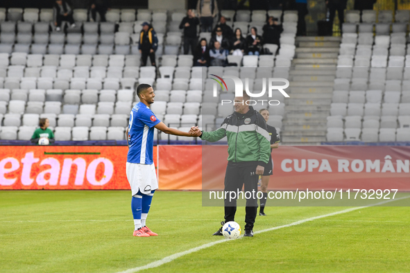 Aurelian Ghisa and Rivaldinho are in action during the Romanian Cup match between Sanatatea Cluj and Farul Constanta at Cluj Arena in Cluj,...