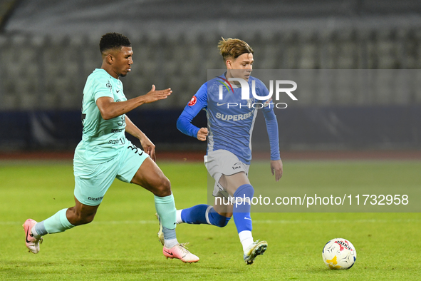 Luca Basceanu and Laley Fofana are in action during the Romanian Cup match between Sanatatea Cluj and Farul Constanta at Cluj Arena in Cluj,...