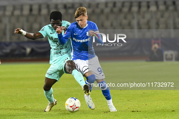 Joseph Aido and Luca Basceanu are in action during the Romanian Cup match between Sanatatea Cluj and Farul Constanta at Cluj Arena in Cluj,...