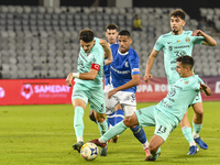 Damian Cimpoiesu, Rivaldinho, and Catalin Cret are in action during the Romanian Cup match between Sanatatea Cluj and Farul Constanta in Clu...