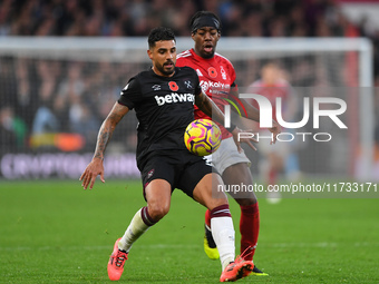 Emerson Palmieri of West Ham United is under pressure from Anthony Elanga of Nottingham Forest during the Premier League match between Notti...