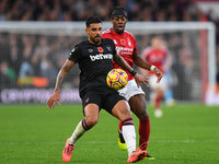 Emerson Palmieri of West Ham United is under pressure from Anthony Elanga of Nottingham Forest during the Premier League match between Notti...