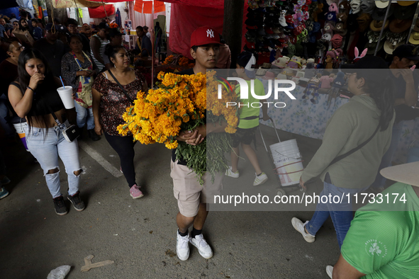 People attend the Tecomitl community cemetery located in the southern end of Mexico City, Mexico, on November 2, 2024, where dozens of peopl...