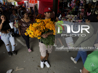 People attend the Tecomitl community cemetery located in the southern end of Mexico City, Mexico, on November 2, 2024, where dozens of peopl...