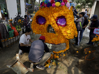 People attend the Tecomitl community pantheon in Mexico City, Mexico, on November 2, 2024, and decorate the graves of their deceased loved o...