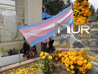 A view of a trans flag at the Tecomitl community cemetery in Mexico City, Mexico, on November 2, 2024, shows dozens of people decorating the...