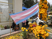 A view of a trans flag at the Tecomitl community cemetery in Mexico City, Mexico, on November 2, 2024, shows dozens of people decorating the...