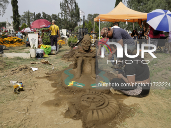 People attend the Tecomitl community pantheon in Mexico City, Mexico, on November 2, 2024, and decorate the graves of their deceased loved o...