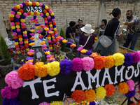 A view of a grave in the Tecomitl community pantheon in Mexico City, Mexico, on November 2, 2024, shows dozens of people decorating the grav...