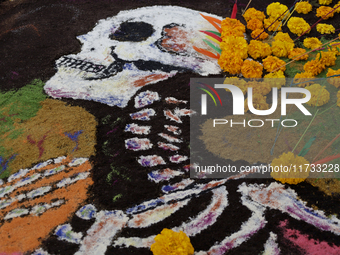 A view of a grave in the Tecomitl community pantheon in Mexico City, Mexico, on November 2, 2024, shows dozens of people decorating the grav...