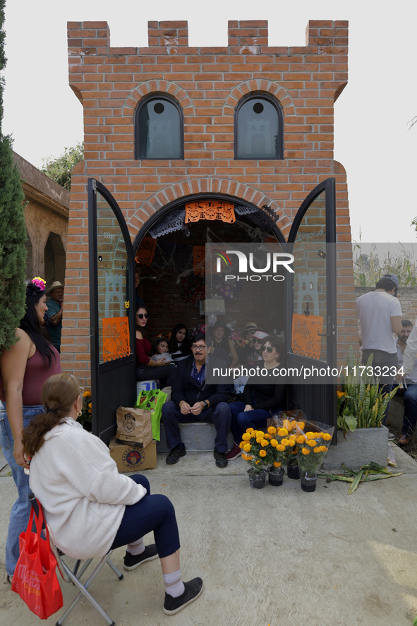 Residents of Tecomitl, located in the southern end of Mexico City, go to the community cemetery on November 2, 2024, to decorate the graves...