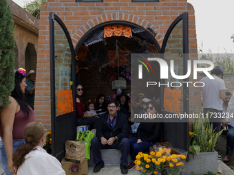 Residents of Tecomitl, located in the southern end of Mexico City, go to the community cemetery on November 2, 2024, to decorate the graves...