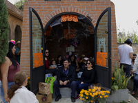 Residents of Tecomitl, located in the southern end of Mexico City, go to the community cemetery on November 2, 2024, to decorate the graves...