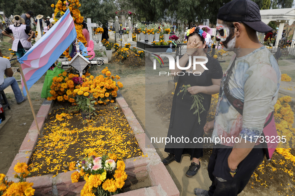 A view of a trans flag at the Tecomitl community cemetery in Mexico City, Mexico, on November 2, 2024, shows dozens of people decorating the...