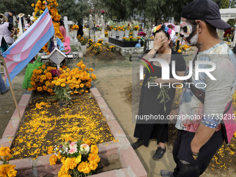 A view of a trans flag at the Tecomitl community cemetery in Mexico City, Mexico, on November 2, 2024, shows dozens of people decorating the...