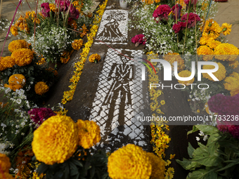 A view of a grave in the Tecomitl community pantheon in Mexico City, Mexico, on November 2, 2024, shows dozens of people decorating the grav...