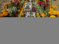 A view of a grave in the Tecomitl community pantheon in Mexico City, Mexico, on November 2, 2024, shows dozens of people decorating the grav...