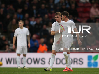 Tommy Conway consoles Hayden Hackney following his red card during the Sky Bet Championship match between Middlesbrough and Coventry City at...