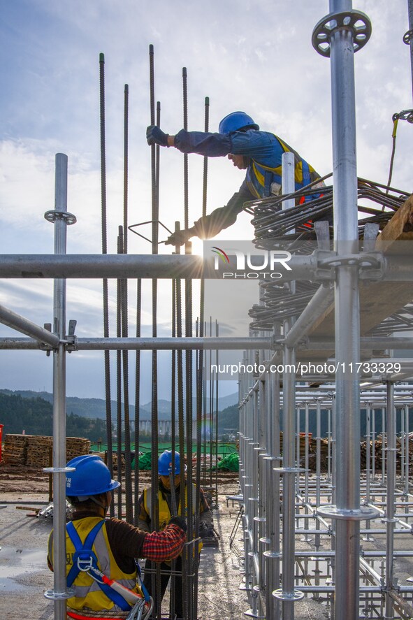 Workers work at the construction site of the Sichuan Can Invest Bazhong (Tongjiang) gas-fired power generation project in Jintang Industrial...