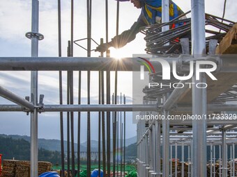 Workers work at the construction site of the Sichuan Can Invest Bazhong (Tongjiang) gas-fired power generation project in Jintang Industrial...