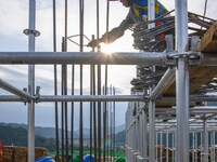 Workers work at the construction site of the Sichuan Can Invest Bazhong (Tongjiang) gas-fired power generation project in Jintang Industrial...