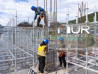 Workers work at the construction site of the Sichuan Can Invest Bazhong (Tongjiang) gas-fired power generation project in Jintang Industrial...