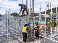 Workers work at the construction site of the Sichuan Can Invest Bazhong (Tongjiang) gas-fired power generation project in Jintang Industrial...