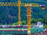 Workers work at the construction site of the Sichuan Can Invest Bazhong (Tongjiang) gas-fired power generation project in Jintang Industrial...