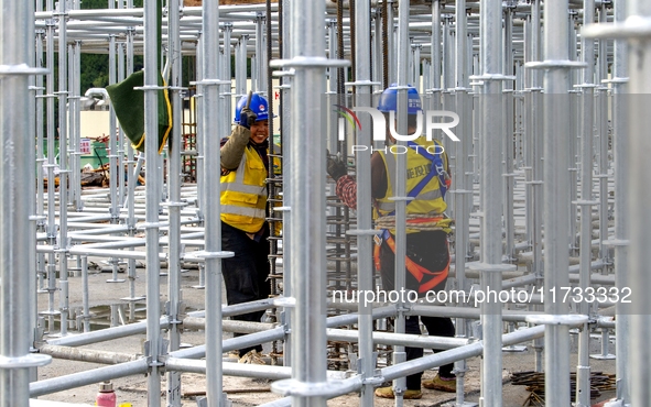 Workers work at the construction site of the Sichuan Can Invest Bazhong (Tongjiang) gas-fired power generation project in Jintang Industrial...