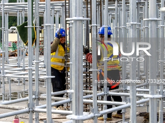 Workers work at the construction site of the Sichuan Can Invest Bazhong (Tongjiang) gas-fired power generation project in Jintang Industrial...