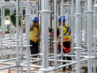 Workers work at the construction site of the Sichuan Can Invest Bazhong (Tongjiang) gas-fired power generation project in Jintang Industrial...