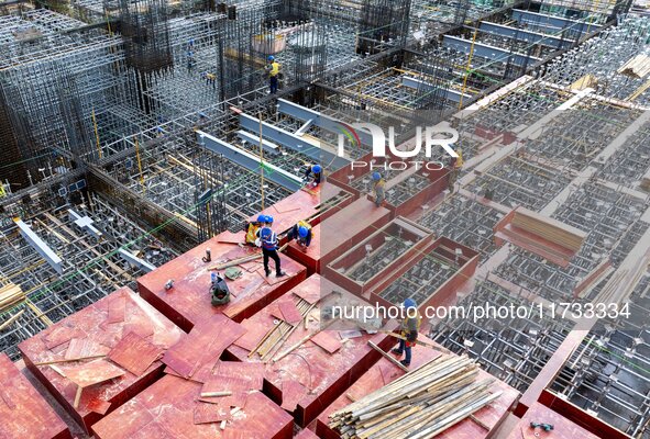 Workers work at the construction site of the Sichuan Can Invest Bazhong (Tongjiang) gas-fired power generation project in Jintang Industrial...